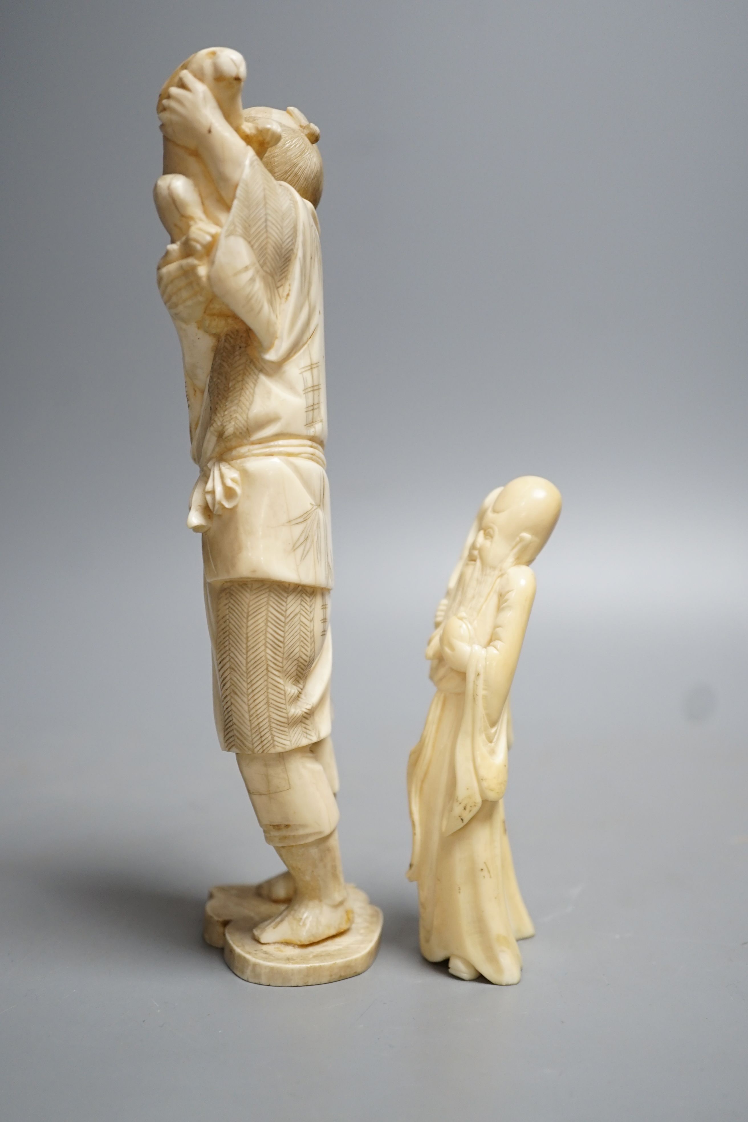 A 19th century Japanese ivory okimono of a man and rabbit together with an early 20th century hippo tooth? Carving of Shou Lao. Largest 19cm